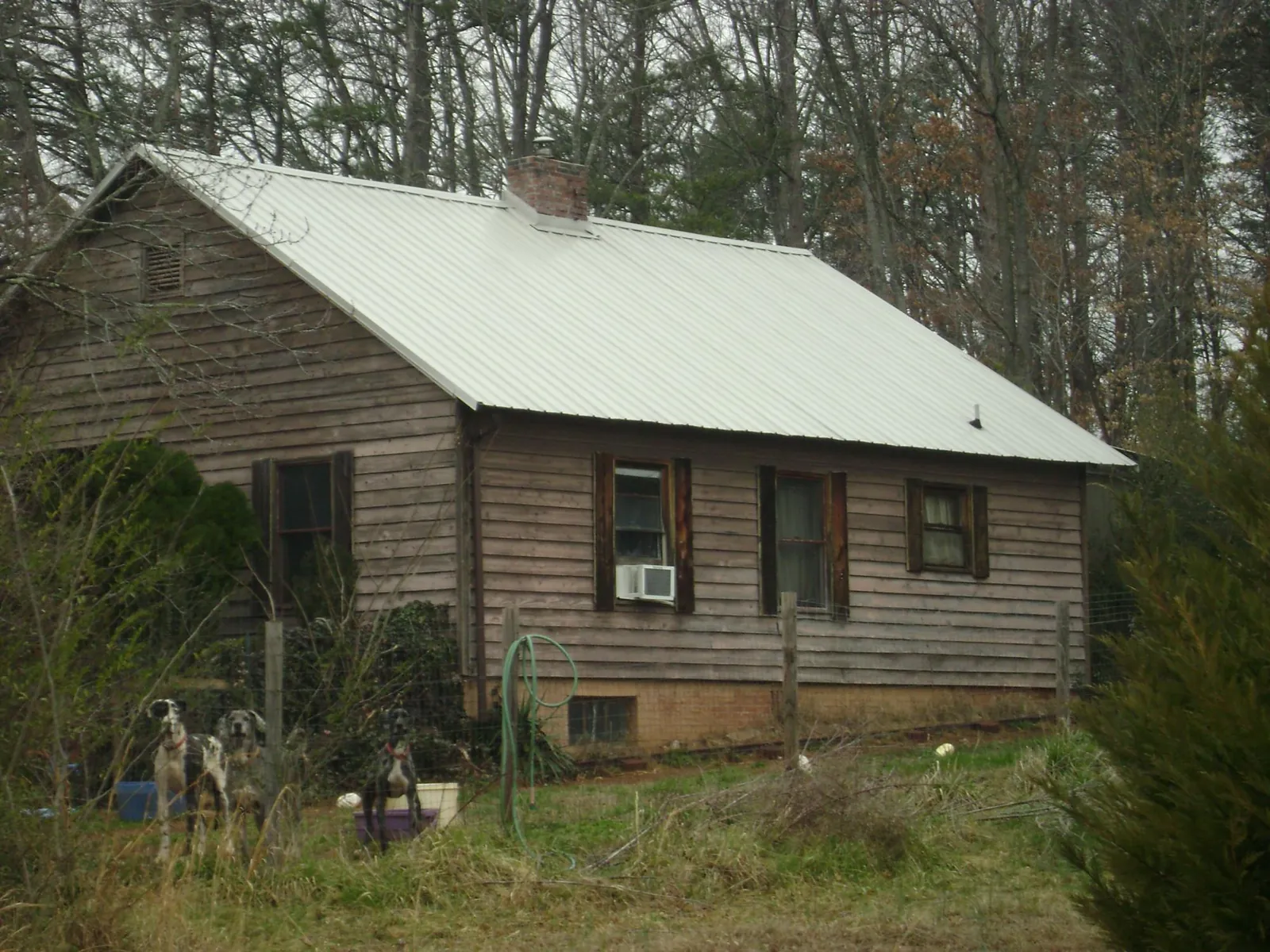 White metal roof on an old wood sided farmhouse, from a Asphalt Shingle Roof Repair job in Keokuk
